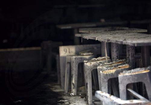 epa13107985 Tables and chairs are covered in ash at the scene of a fatal fire at a pub in Bangkok, Thailand, 13 July 2026. At least 27 people were killed and 63 others were injured after a fire engulfed the pub, according to the Royal Thai Police.  EPA/RUNGROJ YONGRIT
