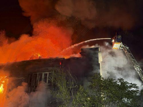 epa13108010 Ukrainian rescuers work as smoke billows from the site of a Russian strike on a residential building in Zaporizhzhia, Ukraine, late 12 July 2026 (issued 13 July 2026), amid the ongoing Russian invasion. According to Zaporizhzhia Oblast Governor Ivan Fedorov, at least 13 people, including a child, were injured following overnight strikes by the...