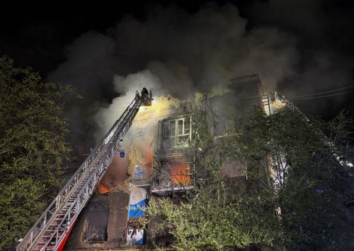 epa13108012 Ukrainian rescuers work to put out the flames at the site of a Russian strike on a residential building in Zaporizhzhia, Ukraine, late 12 July 2026 (issued 13 July 2026), amid the ongoing Russian invasion. According to Zaporizhzhia Oblast Governor Ivan Fedorov, at least 13 people, including a child, were injured following overnight strikes by...