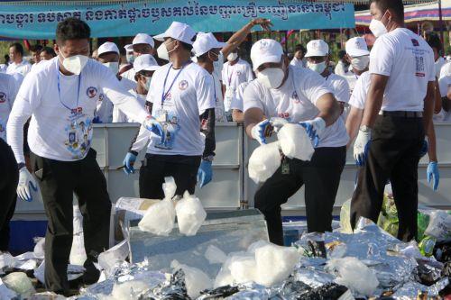 epa13124116 Cambodian officials prepare to burn seized illegal drugs during a drug destruction event in Kandal province, Cambodia, 21 July 2026. The Cambodian National Authority for Combating Drugs destroyed nearly five tons of illegal drug substance ingredients in an effort to fight against drug production, distribution and drug trafficking.  EPA/KITH SEREY