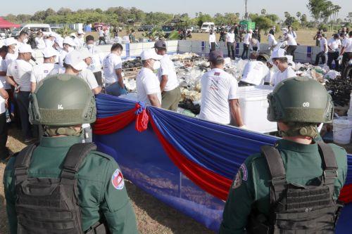 epa13124123 Cambodian police officers stand guard during a drug destruction event in Kandal province, Cambodia, 21 July 2026. The Cambodian National Authority for Combating Drugs destroyed nearly five tons of illegal drug substance ingredients in an effort to fight against drug production, distribution and drug trafficking.  EPA/KITH SEREY