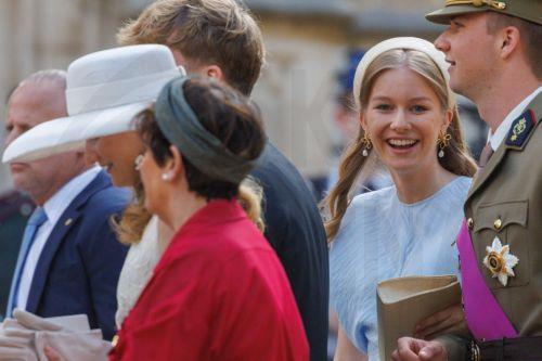 epa13124362 Princess Elisabeth of Belgium (L) followed by Princess Eleonore and Prince Gabriel greet people outside the St. Michael & St. Gudula Cathedral after the Te Deum mass during Belgium's National Day celebrations in Brussels, Belgium, 21 July 2026.  EPA/OLIVIER MATTHYS