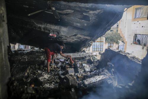 epa13124384 A Palestinian inspects the destroyed house of the Al-Masri family following an Israeli attack, in Gaza City, Gaza Strip, 21 July 2026. Firas Al-Masri, his wife, Salsabil, and their four children were killed in Gaza City, when the Israeli army targeted their home with a drone early 21 July, according to the Gaza Ministry of Health.  EPA/MOHAMMED...