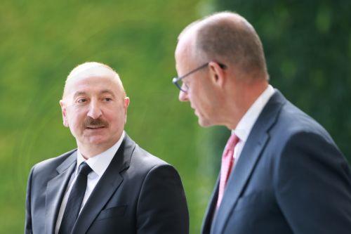 epa13124389 German Chancellor Friedrich Merz (R) welcomes Azerbaijani President Ilham Aliyev with military honors at the Chancellery in Berlin, Germany, 21 July 2026. Merz and Aliyev met for bilateral talks.  EPA/CLEMENS BILAN