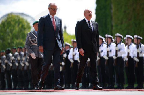 epa13124395 German Chancellor Friedrich Merz (L) welcomes Azerbaijani President Ilham Aliyev with military honors at the Chancellery in Berlin, Germany, 21 July 2026. Merz and Aliyev met for bilateral talks.  EPA/CLEMENS BILAN