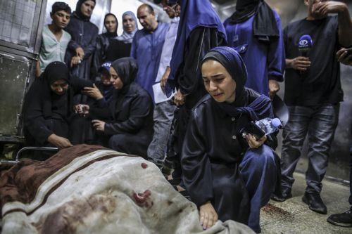 epa13124412 Palestinian relatives of the Al-Masri family mourn near their bodies in the morgue of Al-Shifa Hospital, in Gaza City, Gaza Strip, 21 July 2026. Firas Al-Masri, his wife, Salsabil, and their four children were killed in Gaza City, when the Israeli army targeted their home with a drone early 21 July, according to the Gaza Ministry of Health. ...