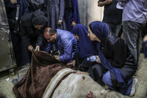 epa13124414 Palestinian relatives of the Al-Masri family mourn near their bodies in the morgue of Al-Shifa Hospital, in Gaza City, Gaza Strip, 21 July 2026. Firas Al-Masri, his wife, Salsabil, and their four children were killed in Gaza City, when the Israeli army targeted their home with a drone early 21 July, according to the Gaza Ministry of Health. ...