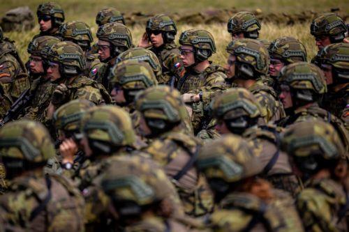 epa13130739 High school students take a rest as they train in basic military skills during the final field exercise of a month-long voluntary military training course organized by the Czech Army at the Hradiste Military Area, near Bochov, Czech Republic, 24 July 2026. The Hradiste Military Area is one of ten sites across the Czech Republic hosting this...