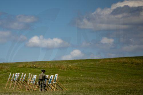 epa13130748 An instructor replaces targets during the final field exercise of a month-long voluntary military training course for high school students organized by the Czech Army at the Hradiste Military Area, near Bochov, Czech Republic, 24 July 2026. The Hradiste Military Area is one of ten sites across the Czech Republic hosting this July's voluntary...