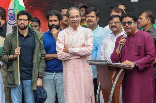 epa13133544 Indian politicians Uddhav Thackeray (2-R), his son Aaditya Thackeray (L), Raj Thackeray (R) and his son Amit Thackeray (2-L) join the supporters of the youth-led satirical political movement Cockroach Janta Party (CJP) as they celebrate the resignation of Union Education Minister Dharmendra Pradhan, in Mumbai, India, 26 July 2026. Pradhan...