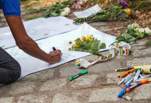 epa13133584 People leave flowers and messages near the scene where a vehicle plowed into a crowd on the sideline of the Christopher Street Day (CSD) parade in Berlin, Germany, 26 July 2026. One person died and 16 others were injured on the sidelines of the Christopher Street Day event in Berlin after a vehicle plowed into a crowd on 25 July 2026, prompting...