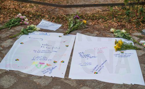 epa13133585 Flowers and messages are left near the scene where a vehicle plowed into a crowd on the sideline of the Christopher Street Day (CSD) parade in Berlin, Germany, 26 July 2026. One person died and 16 others were injured on the sidelines of the Christopher Street Day event in Berlin after a vehicle plowed into a crowd on 25 July 2026, prompting...