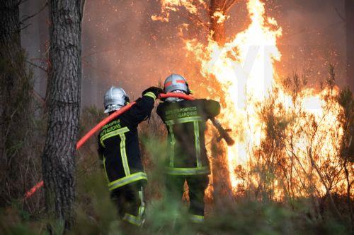 epa13134816 A crew of French firefighters is deployed to battle a wildfire spreading in Cestas-Pierroton, south-western France, 26 July 2026. According to a recent report from the French Ministry of the Interior, 167,000 people have been evacuated and at least 98,000 hectares have been burned since the beginning of the wildfires in and around Cap Ferret...