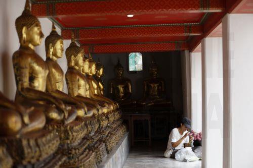 epa13141334 A Thai devotee prepares lotus flowers to offer to Buddhist monks during the floral alms offering ceremony marking the start of Buddhist Lent or 'Khao Phansa' at Wat Phra Chetuphon Wimonmangkalaram Ratchaworamahawihan or Wat Pho in Bangkok, Thailand, 30 July 2026. The traditional floral alms offering is held to mark the start of Buddhist Lent,...