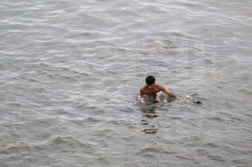 epa13143770 A young man who returned from Spain swims near the Bab Sebta border crossing near Fnideq, Morocco, 31 July 2026. The unrest erupted as thousands gathered near the border, some attempted to cross into Ceuta and clashed with Moroccan security forces.  EPA/JALAL MORCHIDI