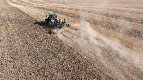 epa13148024 A drone picture shows a tractor cultivating a harvested field while sowing a cover crop amid extremely dry conditions near Gembloux, Belgium, 03 August 2026. Belgium is under an orange heat warning issued by the Royal Meteorological Institute (RMI/IRM), with temperatures expected to reach up to 36 degrees Celsius, as much of the country...