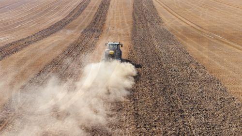 epa13148029 A drone picture shows a tractor cultivating a harvested field while sowing a cover crop amid extremely dry conditions near Gembloux, Belgium, 03 August 2026. Belgium is under an orange heat warning issued by the Royal Meteorological Institute (RMI/IRM), with temperatures expected to reach up to 36 degrees Celsius, as much of the country...