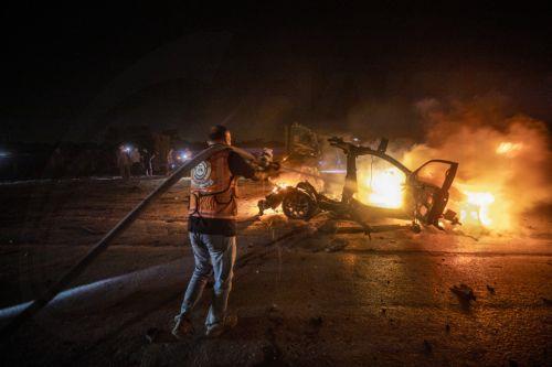epa13149105 Palestinian Civil Defense personnel extinguish a fire in a destroyed car following an Israeli airstrike on Al-Rashid Road next to the beach in southern Gaza City, 03 August 2026. According to the Gaza Health Ministry,  two Palestinians were killed in the strike.  EPA/MOHAMMED SABER