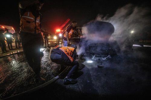 epa13149106 Palestinian Civil Defense personnel extinguish a fire in a destroyed car following an Israeli airstrike on Al-Rashid Road next to the beach in southern Gaza City, 03 August 2026. According to the Gaza Health Ministry, two Palestinians were killed in the strike.  EPA/MOHAMMED SABER