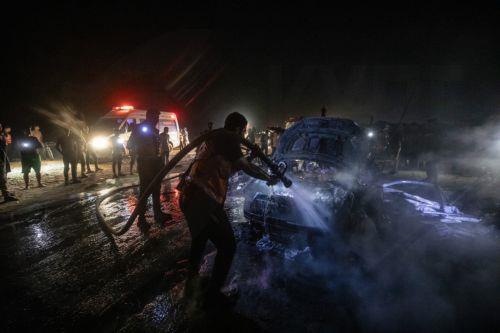 epa13149108 Palestinian Civil Defense personnel extinguish a fire in a destroyed car following an Israeli airstrike on Al-Rashid Road next to the beach in southern Gaza City, 03 August 2026. According to the Gaza Health Ministry,  two Palestinians were killed in the strike.  EPA/MOHAMMED SABER