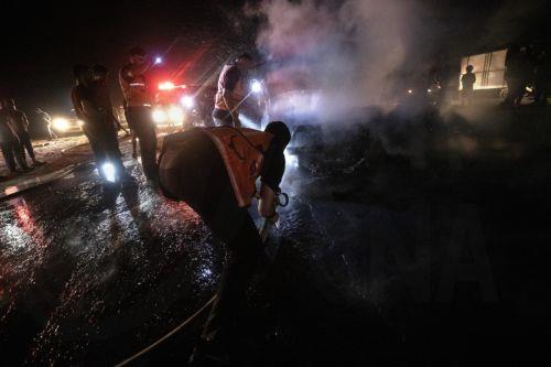 epa13149115 Palestinian Civil Defense personnel extinguish a fire in a destroyed car following an Israeli airstrike on Al-Rashid Road next to the beach in southern Gaza City, 03 August 2026. According to the Gaza Health Ministry, two Palestinians were killed in the strike.  EPA/MOHAMMED SABER