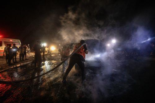 epa13149117 Palestinian Civil Defense personnel extinguish a fire in a destroyed car following an Israeli airstrike on Al-Rashid Road next to the beach in southern Gaza City, 03 August 2026. According to the Gaza Health Ministry, two Palestinians were killed in the strike.  EPA/MOHAMMED SABER