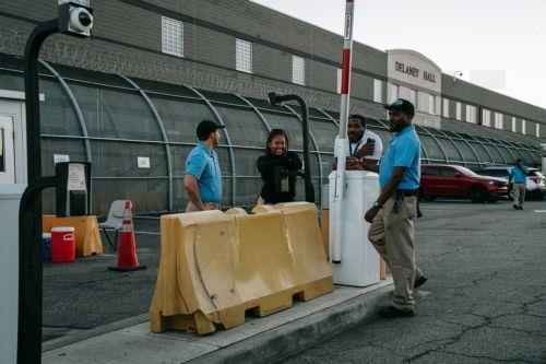 epa13149222 GEO Group employees are seen inside the facility’s gate at the Delaney Hall Immigration Detention Facility during a vigil and protest for Edwin Jovanny Lopez Cornejo, in Newark, New Jersey, USA, 03 August 2026. At least 54 people have died in ICE custody since the start of the second Trump administration.  EPA/OLGA FEDOROVA