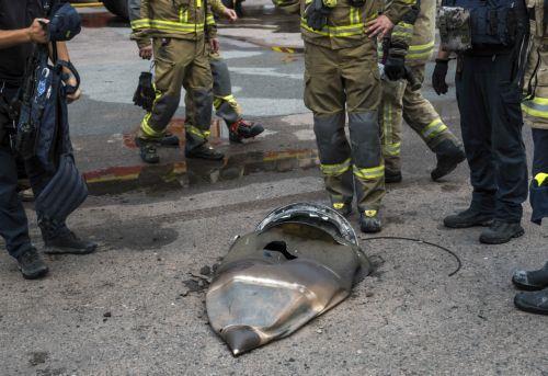 epa13151119 Ukrainian rescuers and experts look at a part of a missile at the site of a Russian missile strike on a postal logistics center in Kyiv, Ukraine, 05 August 2026, amid the Russian invasion. At least 17 people were killed, and more than 40 others were injured in a large-scale overnight Russian attack by ballistic missiles on Kyiv and its area,...
