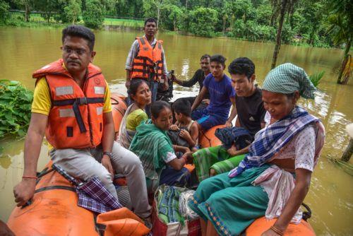 epa13151286 State Disaster Response Fund (SDRF) personnel rescue residents from a flooded area following heavy monsoon rains in Kalapani village, Nagaon district, Assam, India, 05 August 2026. According to the Assam State Disaster Management Authority (ASDMA), the death toll from severe flooding in the north-eastern state of Assam has risen to 89, with over...