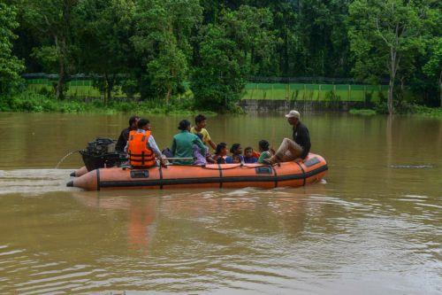 epa13151287 State Disaster Response Fund (SDRF) personnel rescue residents from a flooded area following heavy monsoon rains in Kalapani village, Nagaon district, Assam, India, 05 August 2026. According to the Assam State Disaster Management Authority (ASDMA), the death toll from severe flooding in the north-eastern state of Assam has risen to 89, with over...