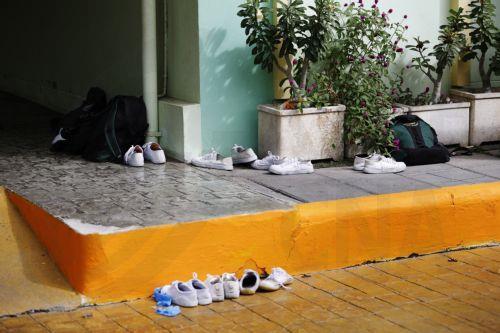 epa13155071 A view of students'shoes and bags left at the scene following a school shooting at Debsirin Nonthaburi School in Bang Kruai district, Nonthaburi province, Thailand, 07 August 2026. Seven people were killed and 15 others injured after a student opened fire inside the school campus before taking his own life, according to a Royal Thai Police...