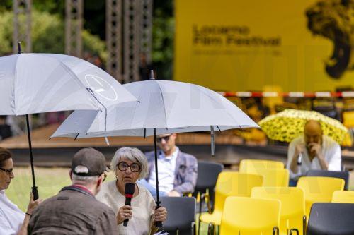 epa13155296 Maja Hoffmann (L), President of the Locarno Film Festival and Swiss Federal Councillor Elisabeth Baume-Schneider (C) are interviewed by Hans Ulrich Obrist (front) near the floor of the podium that collapsed before at the Fondazione Monte Verita on the sideline of the 79th Locarno Film Festival, in Ascona near Locarno, Switzerland, 07 August...