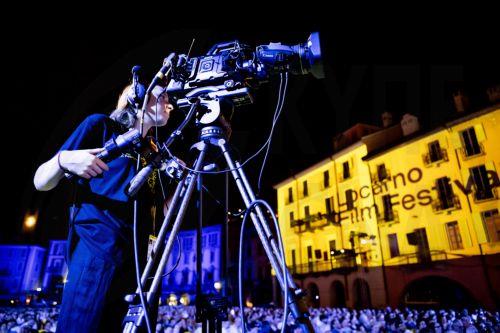 epa13165252 A woman is filming the speeches on the Piazza Grande stage with her camera during the 79th Locarno Film Festival, in Locarno, Switzerland, 12 August 2026.  EPA/JEAN-CHRISTOPHE BOTT