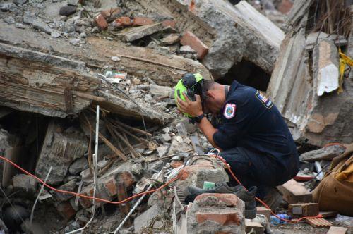 epa13175008 Rescuers search through the rubble of the Torres del Limonar building, destroyed by an earthquake, in Cali, Colombia, 16 August 2026. Dozens of rescuers from various countries work to recover bodies from under the debris a week after the earthquake.  EPA/Mario Baos