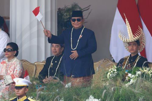 epa13175235 Indonesia’s President Prabowo Subianto (C) waves a flag as Vice President Gibran Rakabuming Raka (R) and Former President Joko Widodo (2-L) looks on during a ceremony marking the 81st anniversary of Indonesia's Independence at the Presidential Palace in Jakarta, Indonesia, 17 August 2026. Indonesia gained independence from the Netherlands on 17...