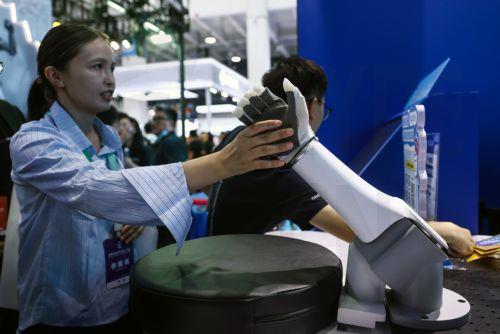 epa13180360  An exhibitor touches a robotic arm during the 2026 World Robot Conference in Beijing, China, 20 August 2026. The WRC event runs from 19 to 23 August.  EPA/WU HAO
