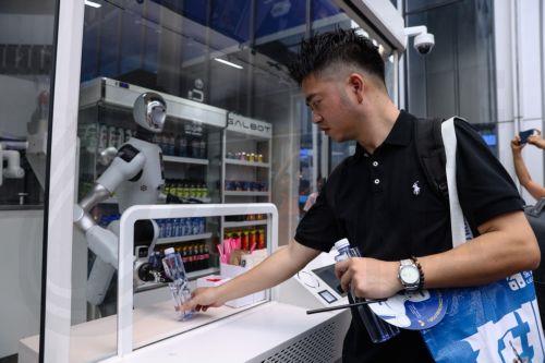 epa13180361 A visitor buys bottled water from a robot-operated automated convenience store during the 2026 World Robot Conference in Beijing, China, 20 August 2026. The WRC event runs from 19 to 23 August.  EPA/WU HAO