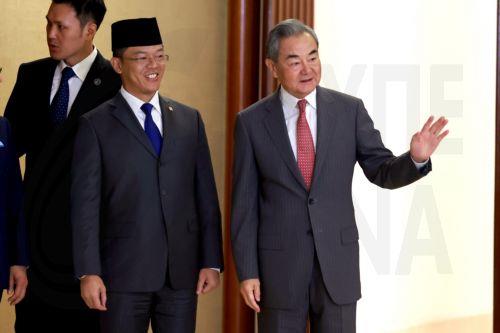 epa13182105 China's Foreign Minister Wang Yi (R) waves as he walks with his Indonesian counterpart Sugiono (C) prior to their meeting in Jakarta, Indonesia, 21 August 2026. Wang Yi is in an official visit to Indonesia to attend comprehensive strategic dialogue Indonesia-China.  EPA/MAST IRHAM