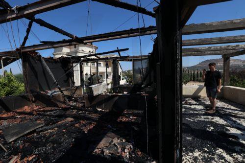 epa13186044 Palestinians inspect the damage to their home in the West Bank village of Usarin, south of Nablus, 23 August 2026. According to the Palestinian Wafa news agency, Israeli settlers set fire to a residential building and partially burned a Palestinian-owned vehicle and scrawled racist slogans in the village of Usarin, south of Nablus, late last...