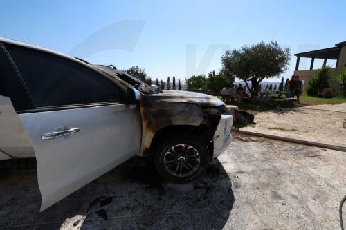epa13186052 Palestinians inspect a damaged vehicle in the West Bank village of Usarin, south of Nablus, 23 August 2026. According to the Palestinian Wafa news agency, Israeli settlers set fire to a residential building and partially burned a Palestinian-owned vehicle and scrawled racist slogans in the village of Usarin, south of Nablus, late last night. ...