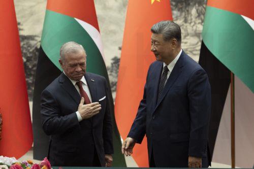 epa13188440 King Abdullah II of Jordan (L) gestures towards China’s President Xi Jinping (R) after a signing ceremony at the Great Hall of the People in Beijing, China, 24 August, 2026.  EPA/ANDRES MARTINEZ CASARES / POOL