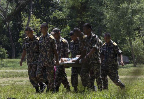 epa13194322 Nepalese Army soldiers carry a survivor who was airlifted to an army base following a flash flood in Trishuli Bazar, Nuwakot district, Nepal, 27 August 2026. More than 160 people have died and hundreds remain missing across northern Nepal after a suspected avalanche triggered massive flash floods and mudslides along the Bhotekoshi and Trishuli...