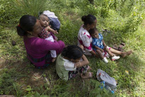 epa13196538 People sits on higher ground following another flash flood alert in Nuwakot district, Nepal, 28 August 2026. More than 460 people have died and hundreds remain missing across northern Nepal after a suspected avalanche triggered massive flash floods and mudslides along the Bhotekoshi and Trishuli river near the Nepal-Tibet border, causing...
