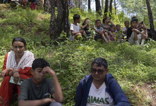epa13196540 People sits on higher ground following another flash flood alert in Nuwakot district, Nepal, 28 August 2026. More than 460 people have died and hundreds remain missing across northern Nepal after a suspected avalanche triggered massive flash floods and mudslides along the Bhotekoshi and Trishuli river near the Nepal-Tibet border, causing...