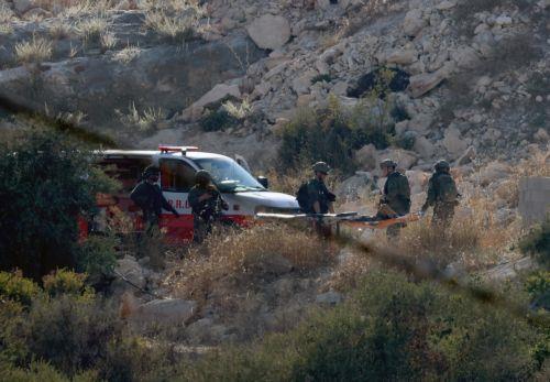 epa13196975 Israeli troops carry the bodies of three Palestinians killed in an airstrike near the West Bank city of Jenin, 28 August 2026. Israel's military reported it conducted a strike against several militants in the Jenin area.  EPA/ALAA BADARNEH