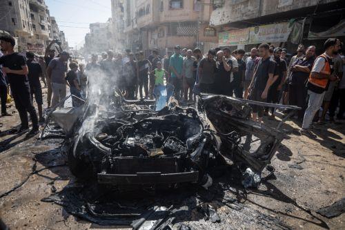 epa13202349 Palestinians inspect a destroyed car following an Israeli air strike on Gaza City, 31 August 2026. According to reports by the Ministry of Health in Gaza, at least three Palestinians were killed in the Israeli attack.  EPA/MOHAMMED SABER