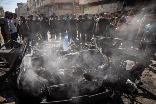 epa13202351 Palestinians inspect a destroyed car following an Israeli air strike on Gaza City, 31 August 2026. According to reports by the Ministry of Health in Gaza, at least three Palestinians were killed in the Israeli attack.  EPA/MOHAMMED SABER