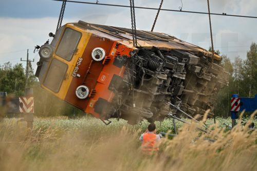 epa13228257 A derailed locomotive is lifted after an accident in Sokolniki Suche, Poland, 10 September 2026. Emergency response teams and technical crews worked to clear the site of a rail accident that occurred on 09 September when a truck collided with a PKP Intercity passenger train traveling on the Lublin–Szczecin route. The impact derailed the...