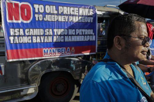 epa13238175 A member of a public transport group stands in front of a banner during a protest as part of a transport strike in Quezon City, Metro Manila, Philippines, 14 September 2026. A public transport organization called Manibela (steering wheel), went on strike to protest fuel price hikes that have been affected by the Middle East conflict. Manibela...