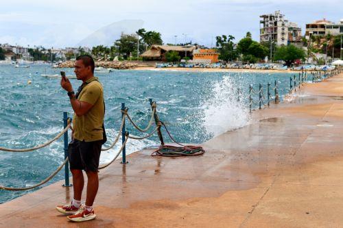 epa13256712 A person watches strong waves in Acapulco, Mexico, 22 September 2026. Hurricane Polo, which reached Category 5, the highest level on the Saffir-Simpson scale, is expected to move slowly off Mexico's Pacific coast, while forecasts for heavy rain in western states remain in effect, according to Mexico's National Meteorological Service (SMN). ...